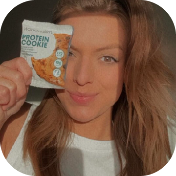 Wonderslim Protein Cookie, Chocolate Chip packaging being held over a Wonderslim Ambassador's face